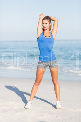 Beautiful fit woman stretching her arm