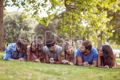 Friends lying and talking in the park