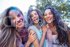 Happy friends covered in powder paint