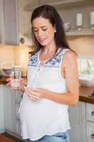Smiling pregnancy taking vitamin