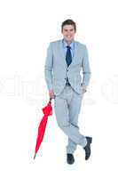 Smiling businessman with umbrella