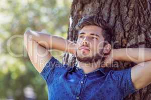 Handsome hipster relaxing in the park