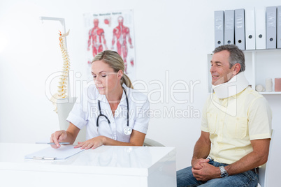 Doctor examining her patient wearing neck brace