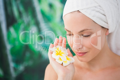 Close up of a beautiful young woman holding flower