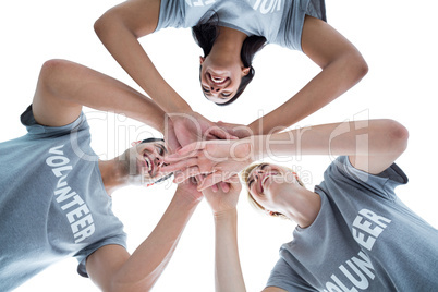 Happy volunteers putting their hands together