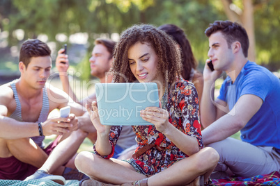 Cute curly hair girl using a tablet