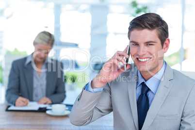 Smiling businessman having a phone call