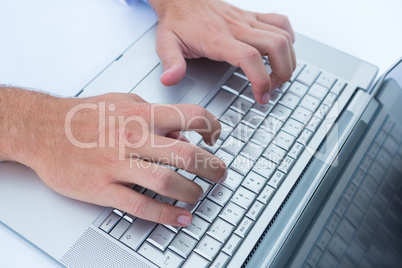 Businessman typing on his laptop