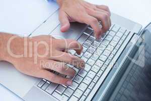 Businessman typing on his laptop