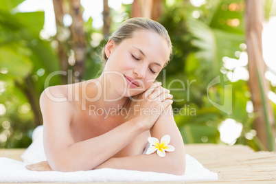 Peaceful blonde lying on towel