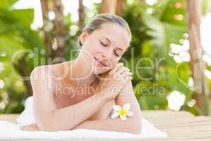 Peaceful blonde lying on towel