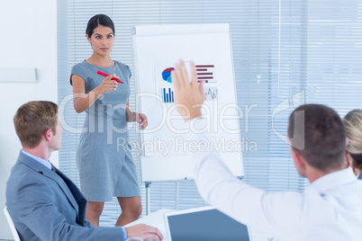 Manager presenting statistics to her colleagues