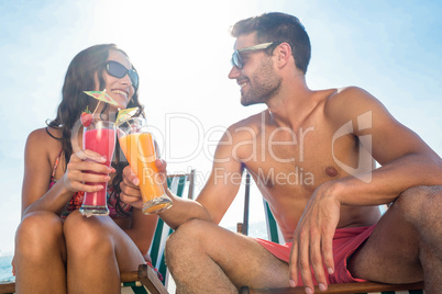 happy couple smiling and drinking cocktail