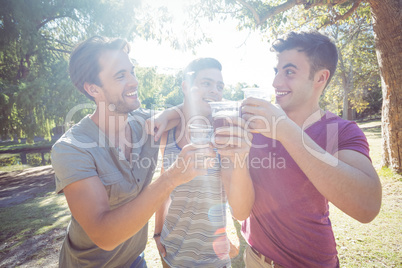 Happy friends in the park having beers