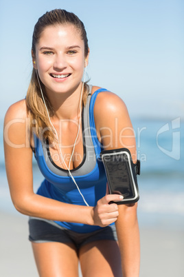 Portrait of beautiful fit woman using her phone