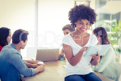 Group of young colleagues using laptop and tablet