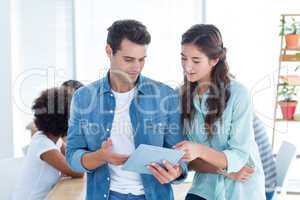 young business people discussing over a tablet