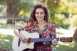 happy girl playing guitar