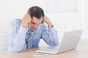 Frustrated businessman working with his computer