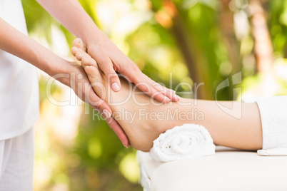 Close-up of a woman receiving foot massage