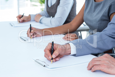 Group of business people taking notes
