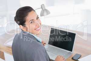 Smiling businesswoman using her computer