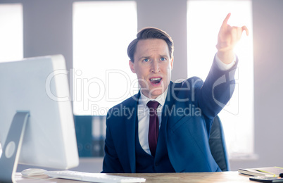 Angry businessman pointing and shouting