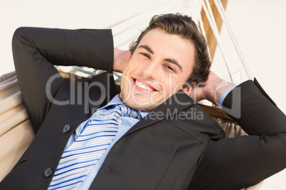 Happy businessman relaxing on the hammock