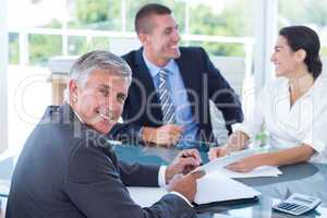 Smiling business people brainstorming together