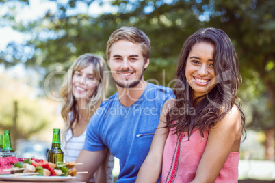 Happy friends in the park having lunch