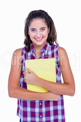 Pretty brunette looking at camera and holding notebook