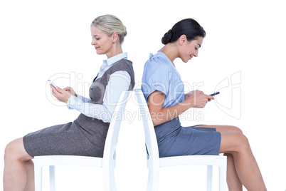 Two businesswomen using smartphone