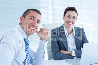 Smiling business people looking at camera