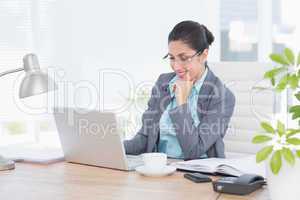 Smiling businesswoman using her computer