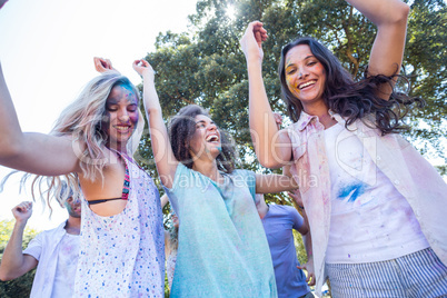 Happy friends covered in powder paint