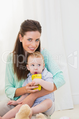 Mother giving baby a drink