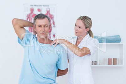 Doctor stretching a man arm