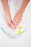 Woman making a hand treatment in a bowl