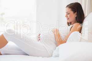 Happy pregnancy sitting on sofa