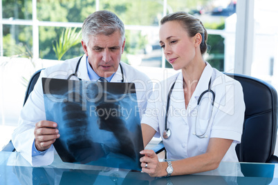 Doctors looking together at xray