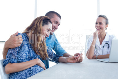 Happy couple looking at ultrasound scan of their baby