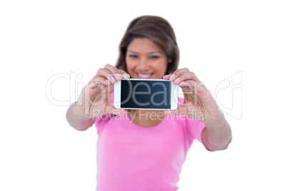 Pretty brunette taking a selfie with smartphone