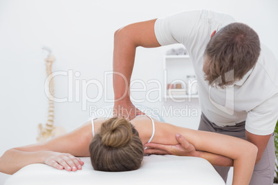 Physiotherapist doing back massage to his patient