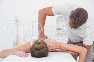 Physiotherapist doing back massage to his patient