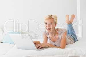 Portrait smiling blonde woman using laptop