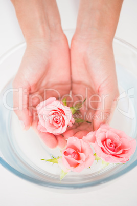 Woman enjoying a hand treatment in a bowl