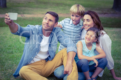 Happy family in the park taking selfie