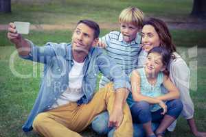 Happy family in the park taking selfie