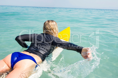 Woman with a surfboard on a sunny day