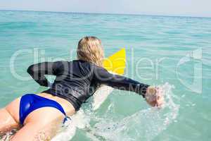 Woman with a surfboard on a sunny day